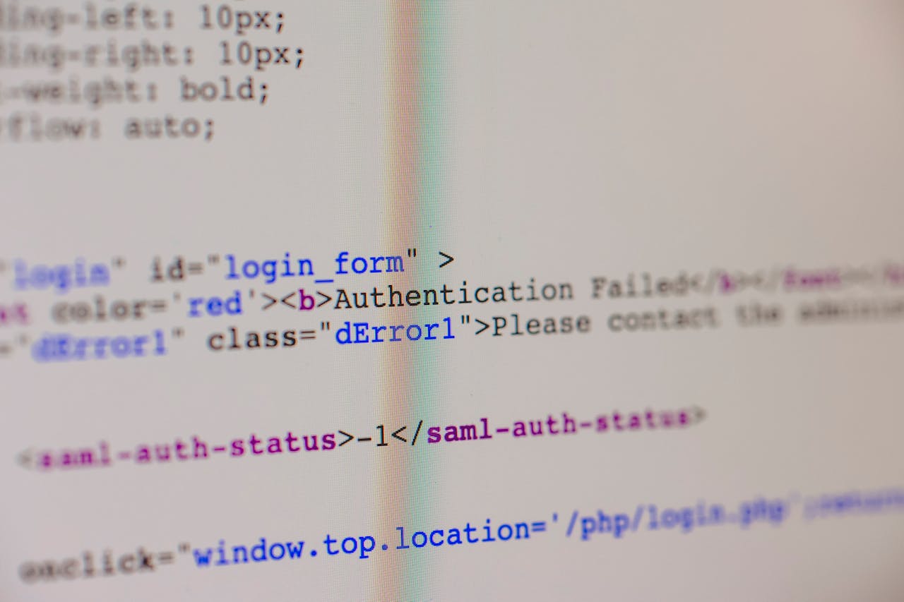 Close-up of HTML and PHP code on screen showing error message and login form data.